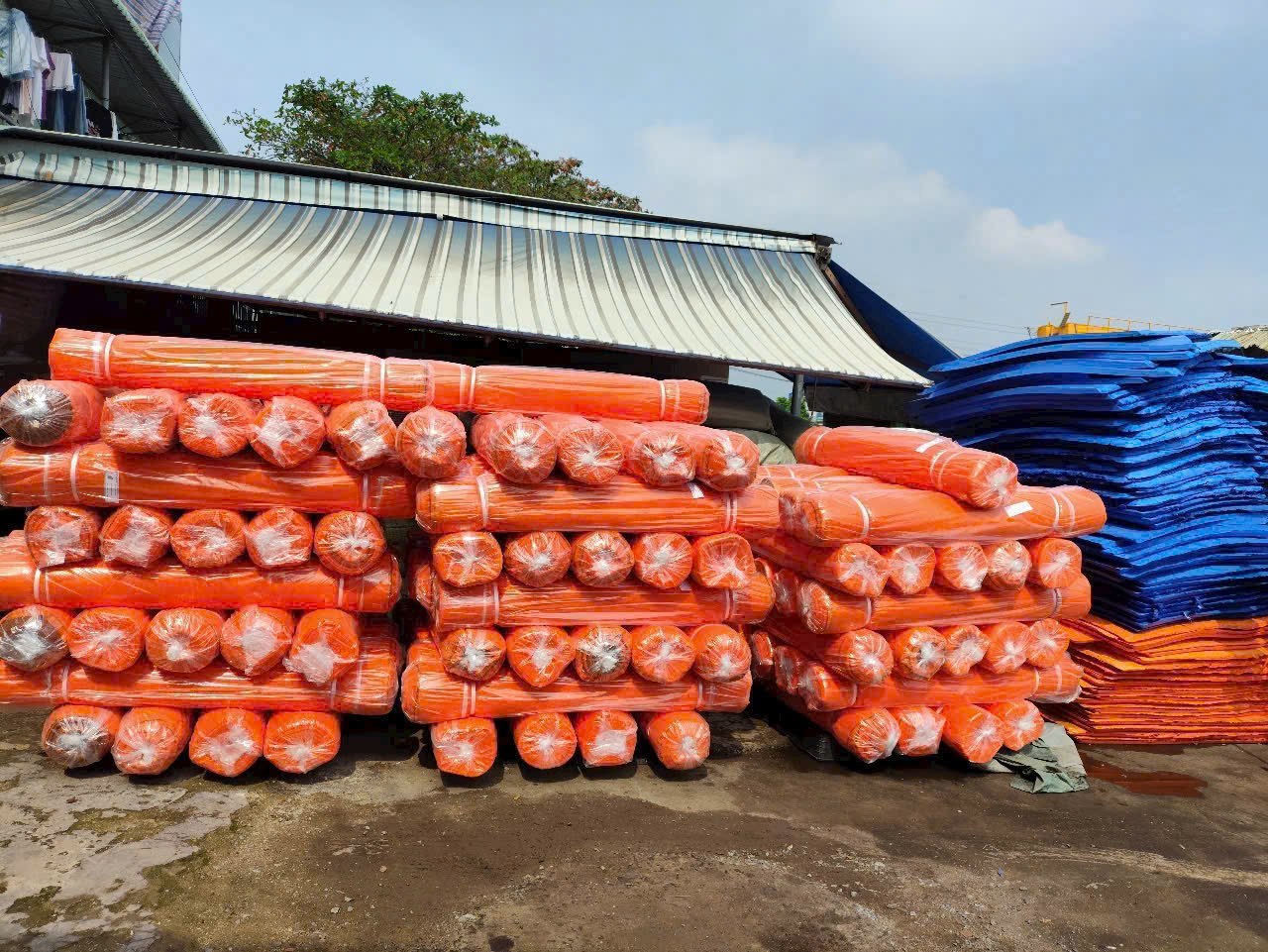 Các cuộn lưới bao che màu cam tập kết thành lô